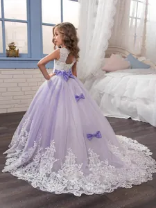 Lavender and white lace flower girl ball gown with a large bow and tulle skirt