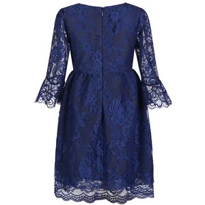 Detail of dark blue lace girl dress with elegant back zipper and scalloped lace edges