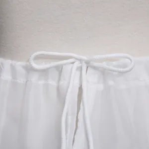 Detail of white satin petticoat waist with adjustable drawstring and ribbon bow