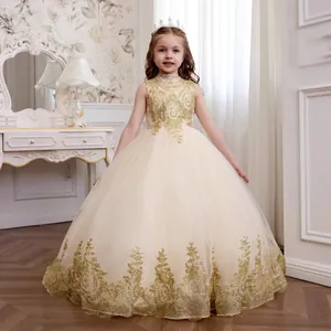 Close-up of luxury cream tulle girl's dress with gold sequins and lace embroidery details