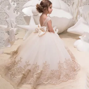 Vestido de niña de encaje champán con gran lazo trasero y cola de tul en capas