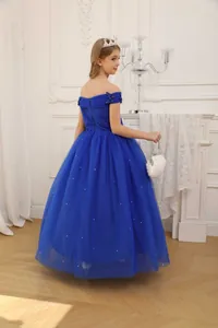 Detail of off-shoulder neckline with bow on a navy blue tulle flower girl dress