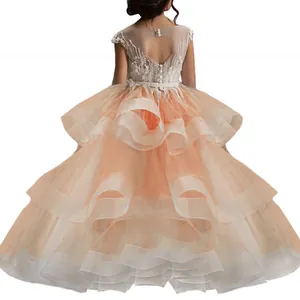 Back view of champagne flower girl dress with heart-shaped cutout and layered tulle skirt