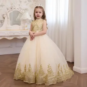 Detail of champagne flower girl dress featuring intricate gold embroidery and tulle