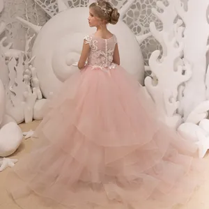 Pink sleeveless tiered tulle flower girl dress with lace back and pearl buttons