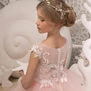 Pink sleeveless trailing flower girl dress with floral embroidery and lace details