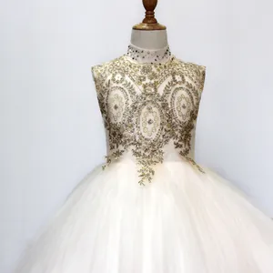 Close-up of golden sequin embroidery and diamond collar on champagne flower girl dress