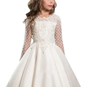 Detailed view of white floral lace bodice and long sheer sleeves on a girl's gown