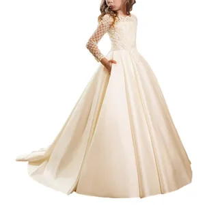 Detail of elegant ivory satin flower girl dress with lace sleeves and side pockets
