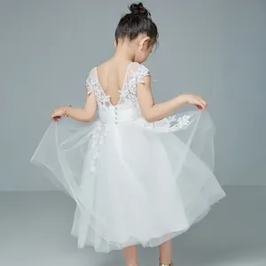 Detail of flower lace embroidery and multi-layer tulle skirt on a white princess dress
