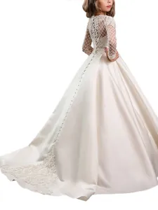 Elegant ivory flower girl dress with lace sleeves and long satin train for formal events