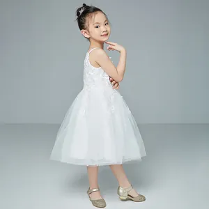 Detail of white flower lace embroidery and layered tulle on children princess dress
