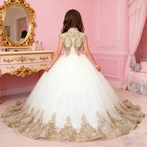 Detail of white girl's princess dress featuring gold sequin embroidery and multi-layer mesh