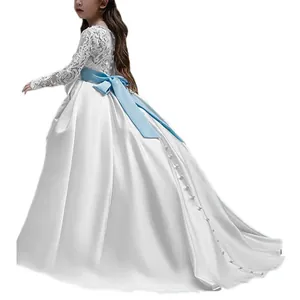 White lace long sleeve flower girl dress with a blue satin ribbon bow and train