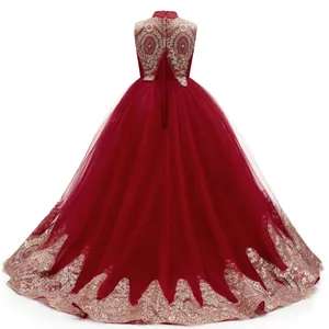 Macro detail of the wine red tulle layers and gold embroidery on the flower girl dress
