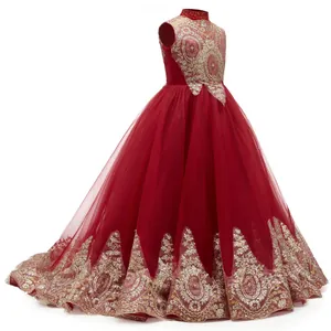 Detail of red flower girl dress featuring intricate gold sequin embroidery and mesh layers