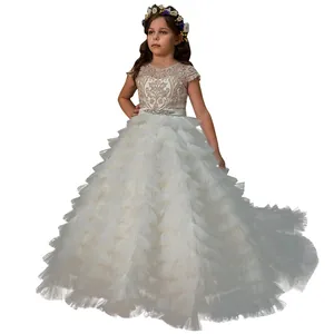 Elegant white sleeveless girls gown with lace bodice and tiered tulle high-low cake train