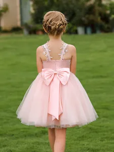 Pink lace flower girl dress with layered tulle and large back bow for birthday party