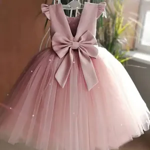Detail of pink flower girl dress featuring tiered mesh skirt and white pearls on tulle
