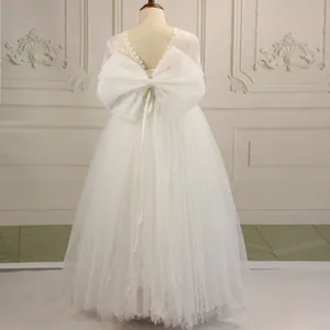 White lace flower girl dress with backless V-neck and oversized bow for weddings