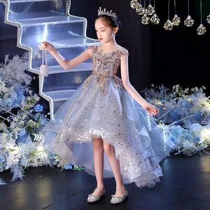 Detail of blue sequined flower girl dress with star pattern and high-low tulle hemline