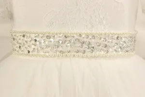Detail of girls princess dress featuring lace bodice and handmade pearl sequin belt