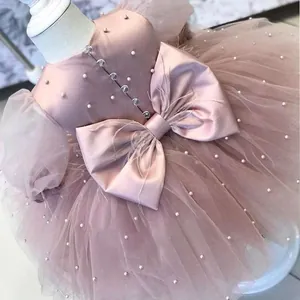 Pink girls princess dress with pearls, puffy tulle skirt, and large back bow detail