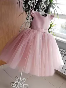 Pink tulle flower girl dress with layered puff skirt and white pearl embellishments