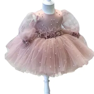 Pink girls princess dress with long mesh sleeves beaded pearls and feather details