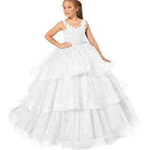 Detail of white flower girl dress showing intricate lace embroidery and layered tulle skirt