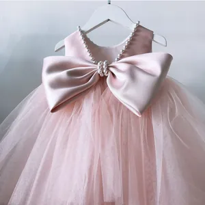 Pink princess tulle flower girl dress with satin bow and pearl collar for parties