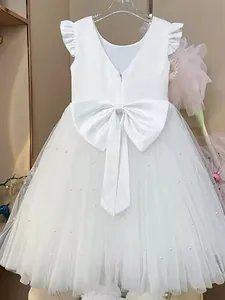 White girls princess dress featuring ruffled sleeves, satin bow and pearl mesh skirt