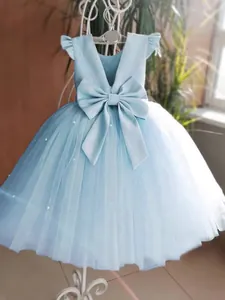 Light blue flower girl dress with a large back bow and layered tulle with pearl accents