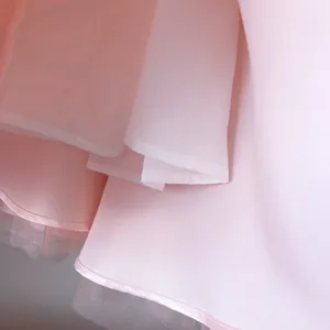 Detail of pink satin layers and tulle mesh hem on a girl's fluffy princess dress