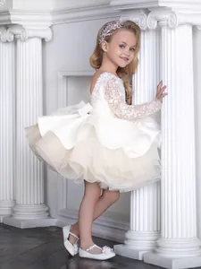 Elegant white long-sleeved flower girl dress with sequins and fluffy tulle skirt