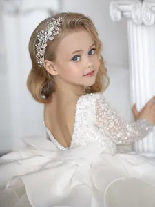 Elegant silver flower headband with pearls and rhinestones on girl in white lace dress