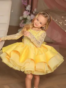 Sparkling yellow long sleeve flower girl dress with sequins and tiered mesh tulle skirt