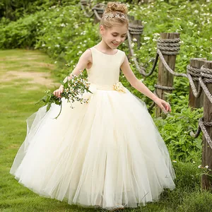 Detail of elegant backless cream lace dress with floral waist accent for girls