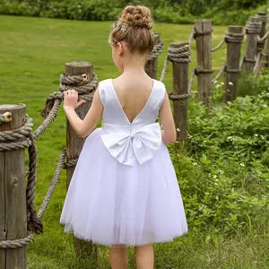 White sleeveless flower girl dress with backless satin bow and layered tulle skirt