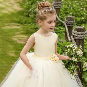 Elegant sleeveless cream tulle flower girl dress with satin bodice and waist floral detail