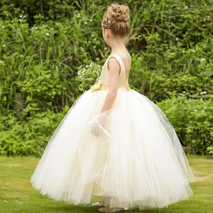 Detail of the backless beige flower girl dress with handmade floral waist decorations