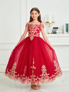 Detailed embroidery of gold vine patterns on a red girls lace princess gown dress