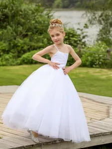 Detailaufnahme weißes Mädchenkleid mit mehrlagigem Netzrock und dünnen Trägern im Freien