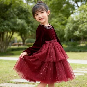 Detail of burgundy velvet bodice with sequins and layered red mesh skirt for girls
