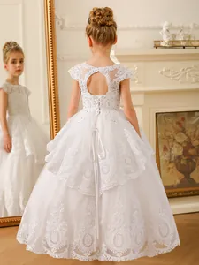 White lace flower girl dress with heart-shaped open back and layered tulle skirt