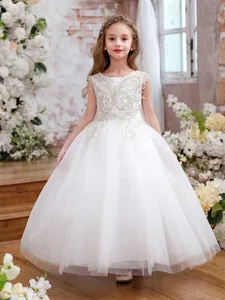 Detailed embroidery and multi-layer tulle textures on champagne flower girl dress