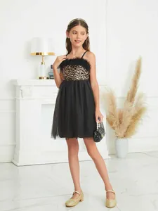 Elegant girl's black tutu dress with gold sequins and black feather neckline detail