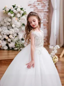 Elegant sleeveless white lace flower girl dress with full tulle skirt and belt detail