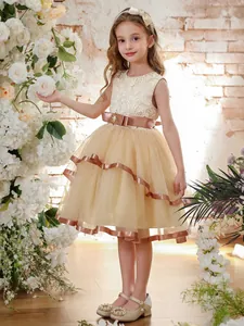 Champagne sleeveless flower girl gown with layered tulle cake skirt and lace bodice