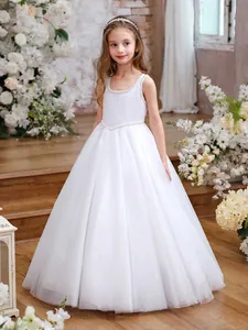 Detailed view of white sleeveless flower girl dress with pearl waist and layered tulle